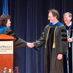 Davis shakes hand of faculty member